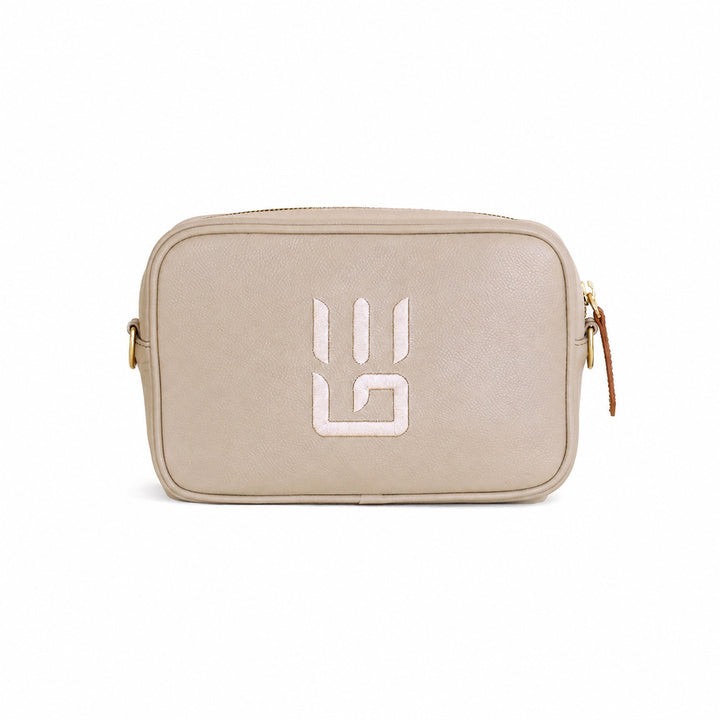 A beige textured leather camera bag with a white stylized &